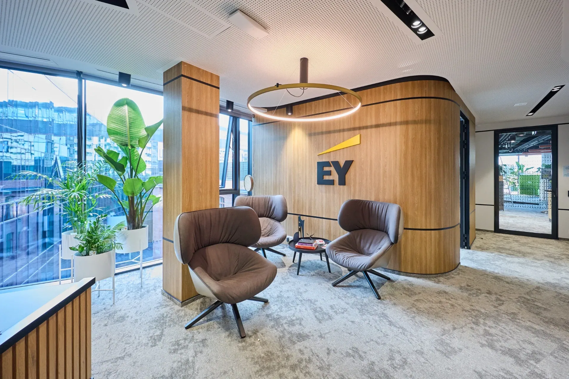EY office interior - lounge area with armchair and coffee table, a MILO Group project